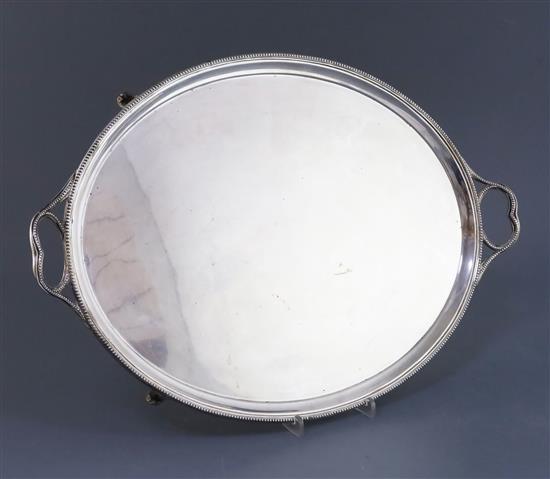 A George V silver oval two handled tea tray by Thomas Bradbury & Sons, 56 oz.